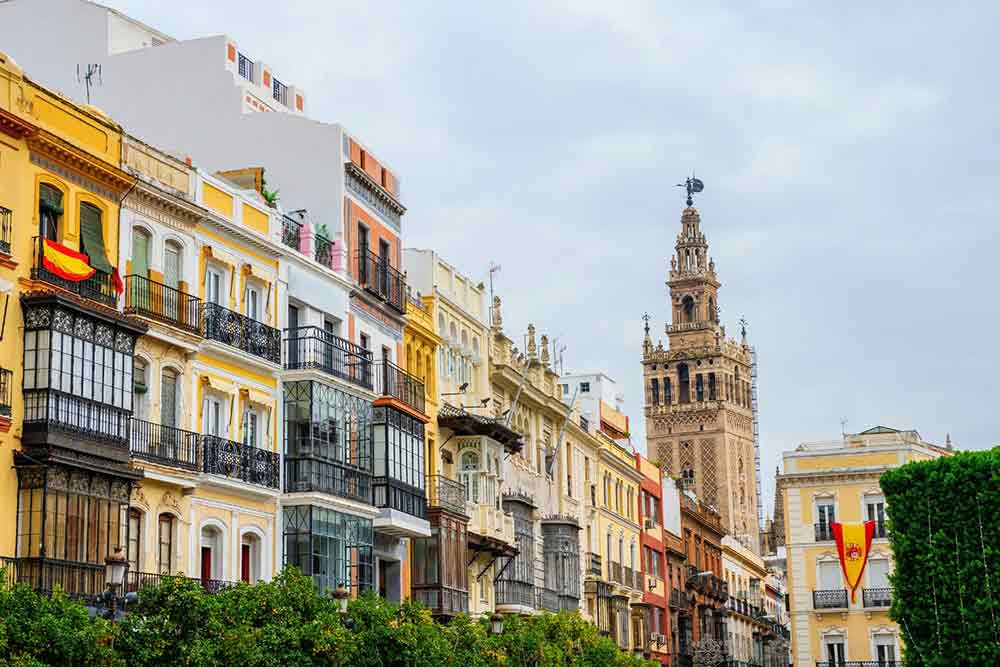 coourful houses and the giralda seen from Plaza de San Francisco