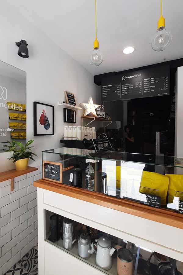 Inside Virgen Coffee, the small counter with coffee making equipemnt and their signiture yellow bags of beans. 