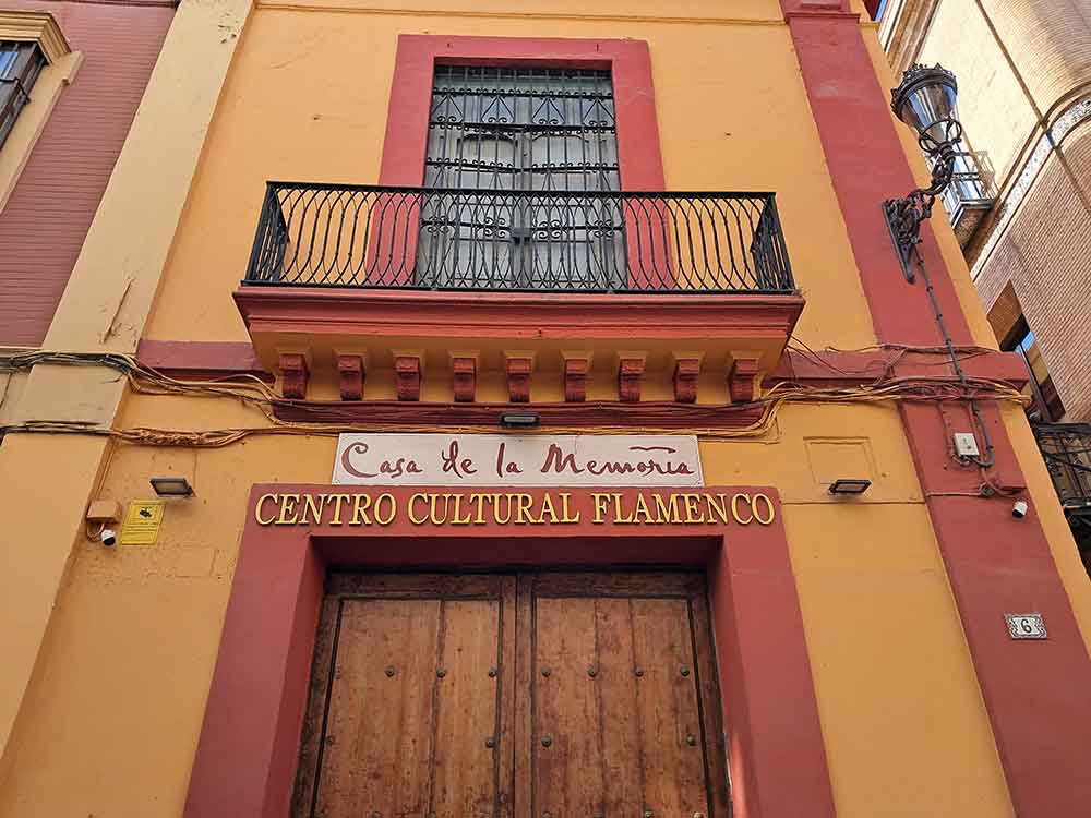 Casa de la Memoria The large wooden doors to Casa de la Memoria with a balcony above.