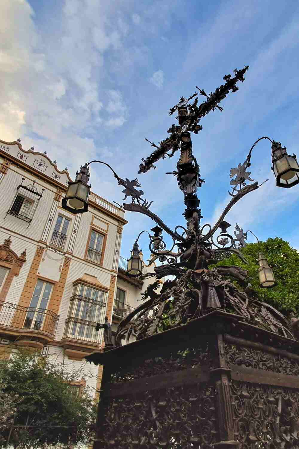 Ornate iron cross in Plaza de Santa Cruz during a spring visit to Seville in May