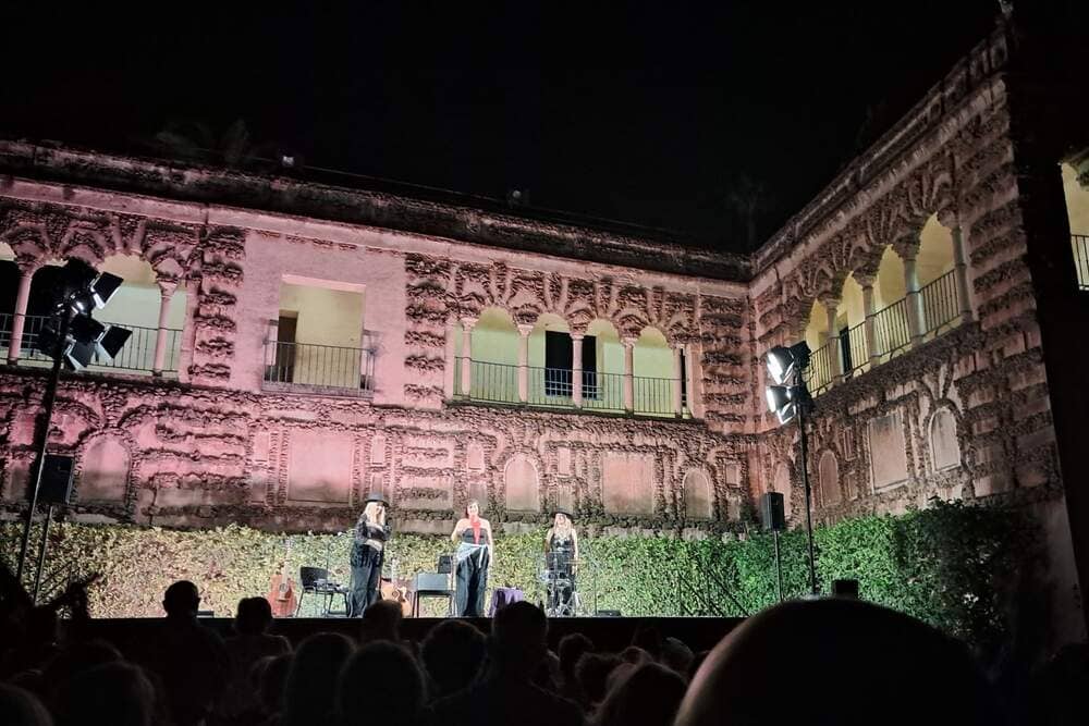 What to do in Seville in June at a summer concert in the Real Alcázar gardens at night.