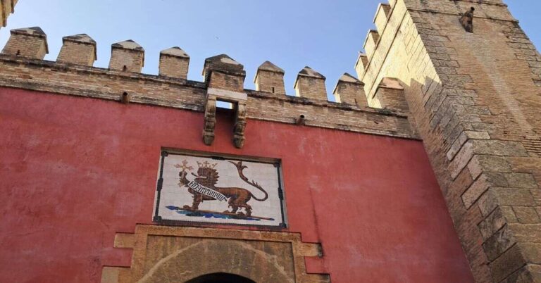 The red Lion Gate at the Alcazar with the lion motif above. This is all you'll see if you can't get in, discover what to do if Seville Alcazar tickets sold out.