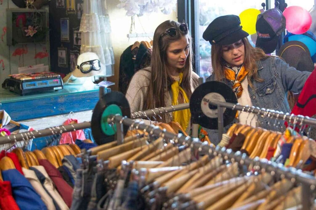 Two girls shopping for vintage clothing. Discover the best vintage shops in Seville